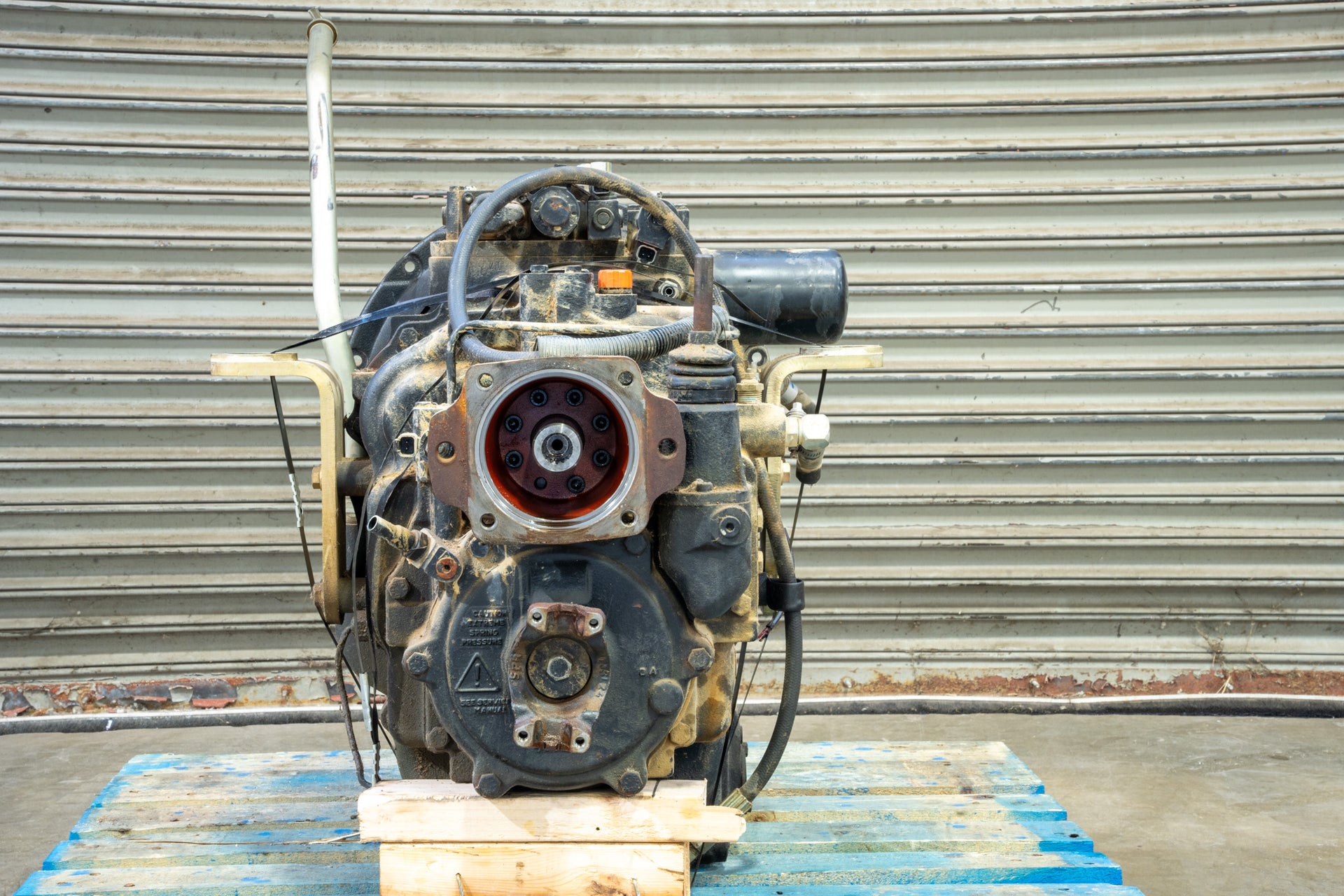 Carraro Transmission close up on blue wood pallet in front of garage door