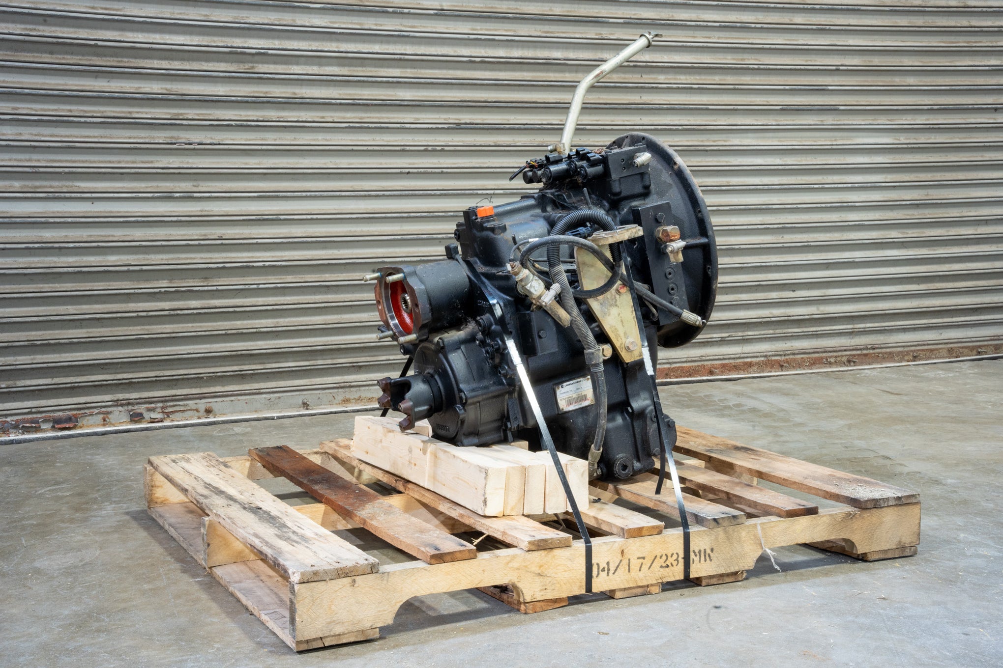 Carraro transmission on wood pallet in front of garage door back right