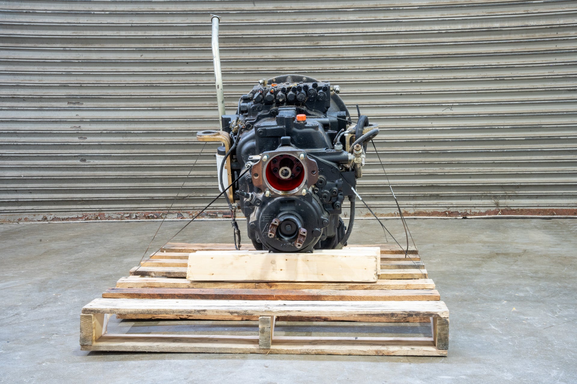 Carraro transmission on wood pallet in front of garage door