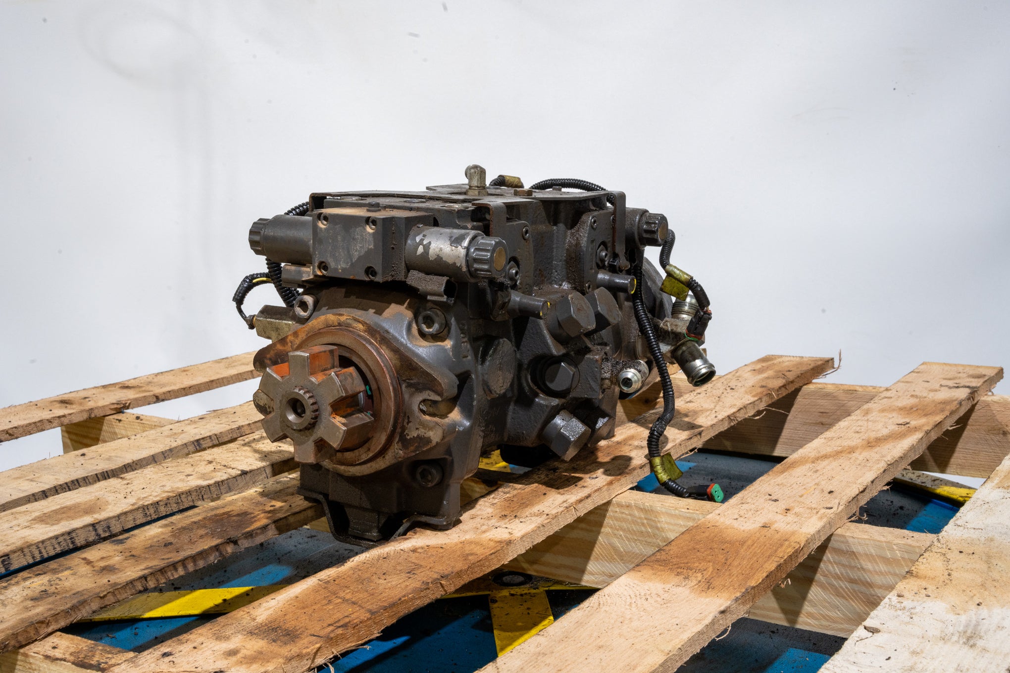 Hydrostatic Pump on wood pallet in front of white background