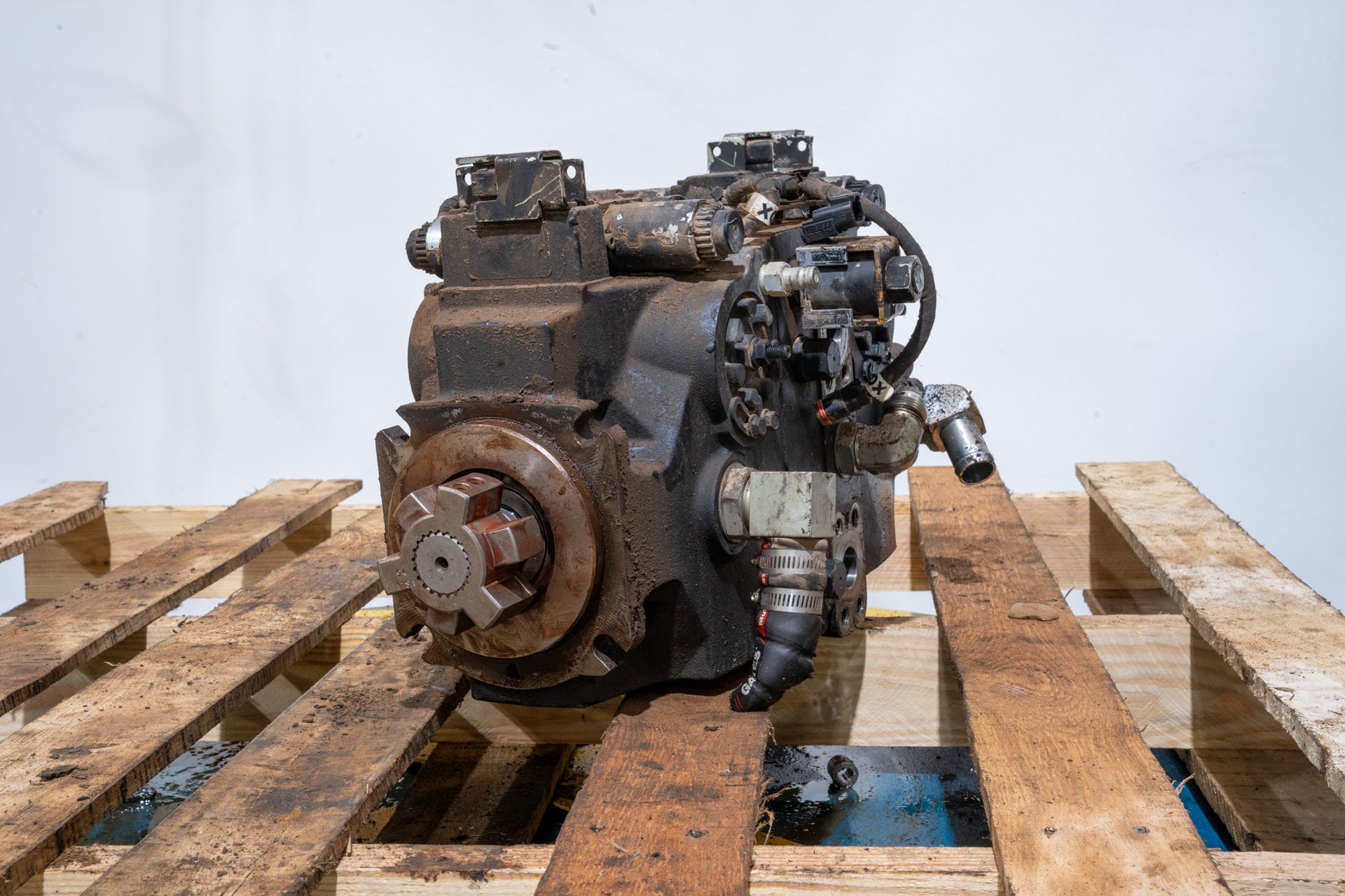 Hydrostatic Pump on wood pallet in front of white background