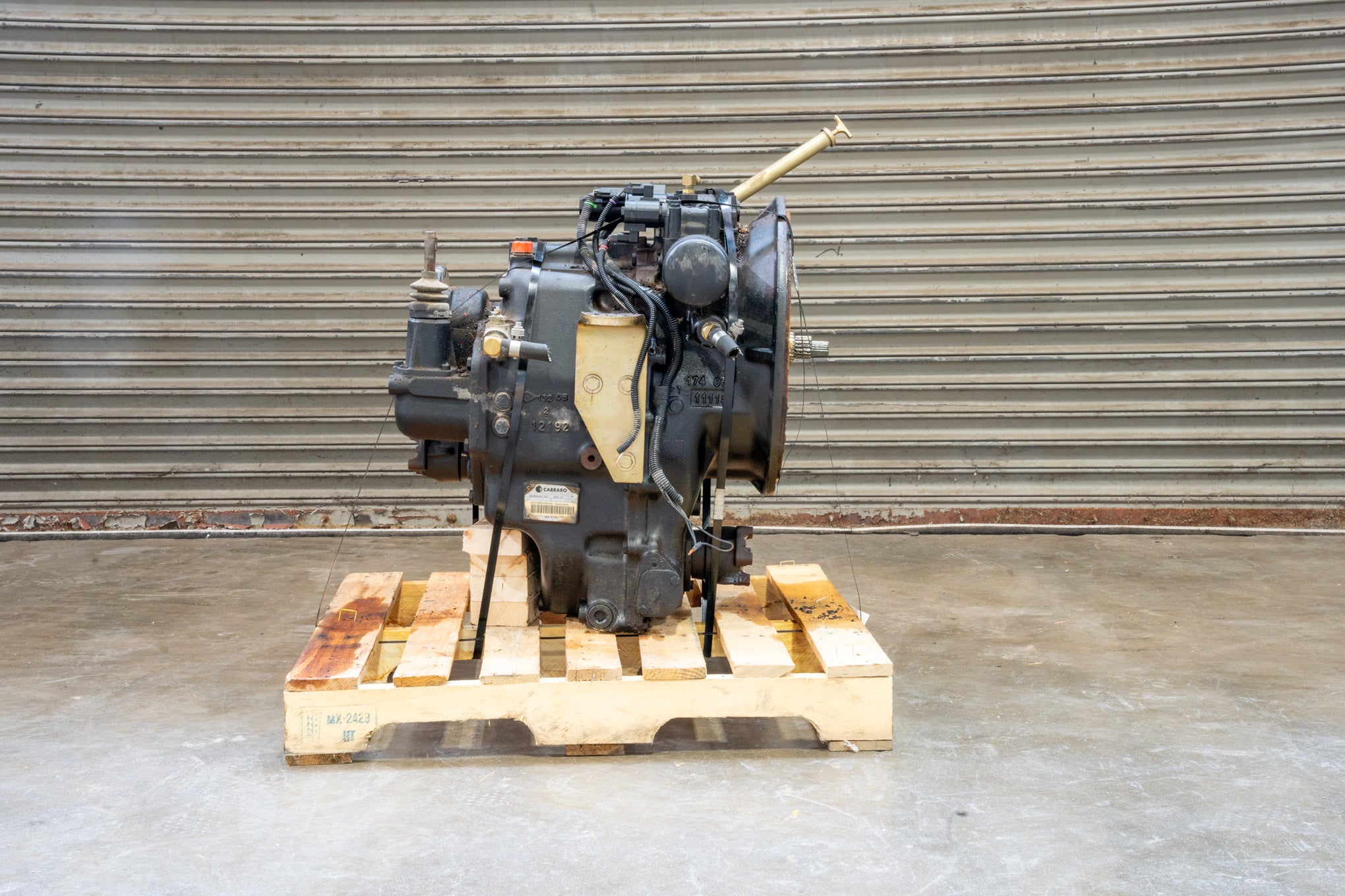 Carraro Backhoe Transmission 87395301 on wood pallet in front of garage