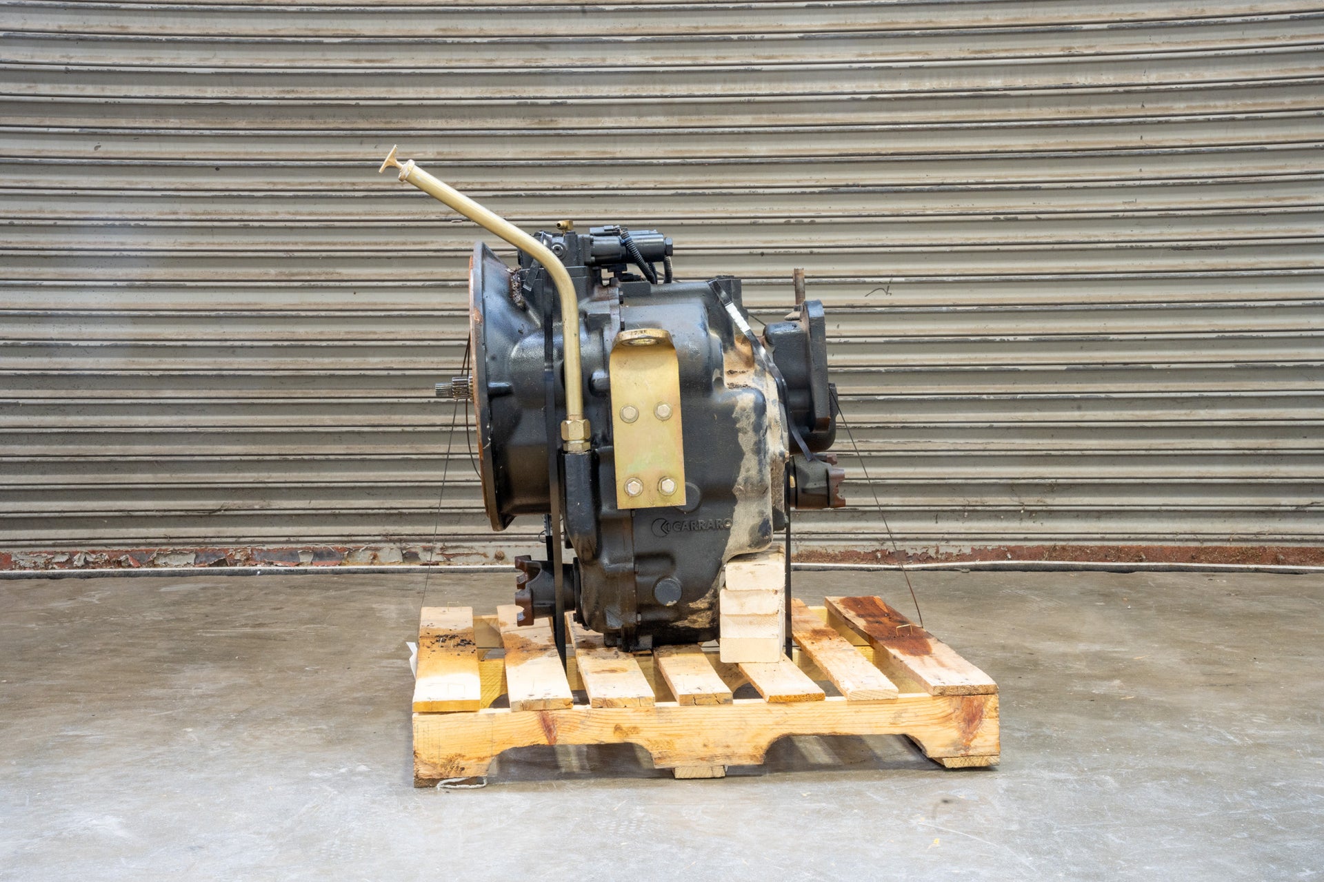 Carraro Backhoe Transmission 87395301 on wood pallet in front of garage